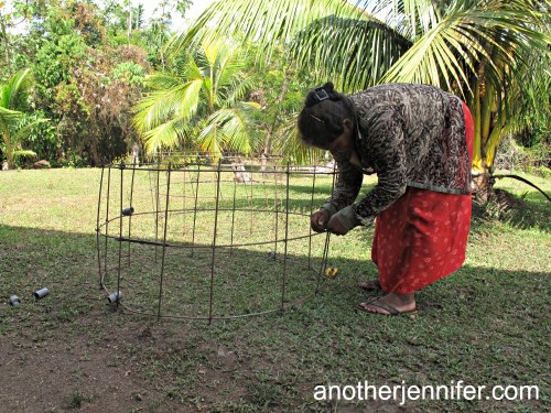 Linda, 41, building casings for a well in her village.